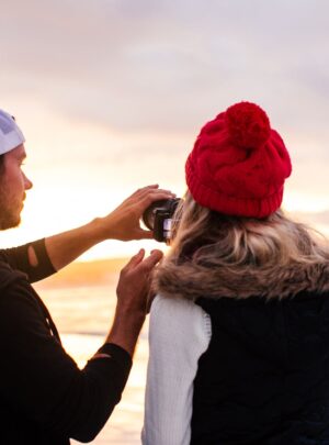 a man and a woman standing on beach